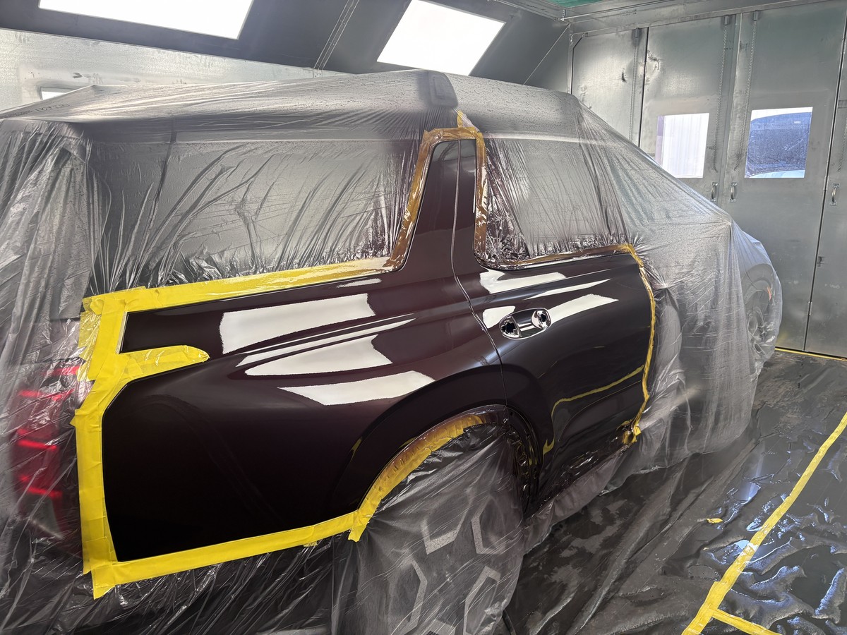SUV door and quarter panel in the paint booth